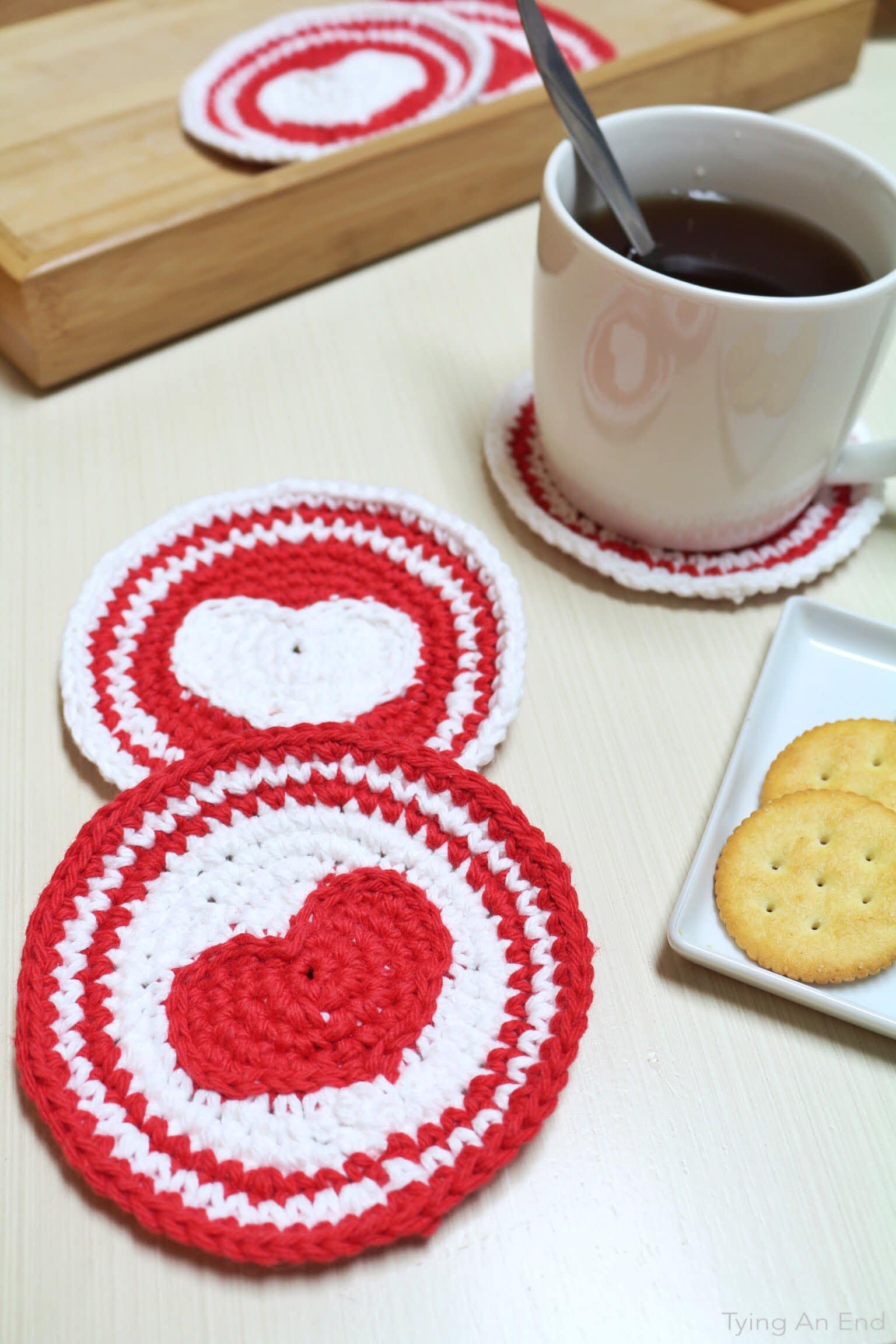 circular crochet coaster with heart in the middle