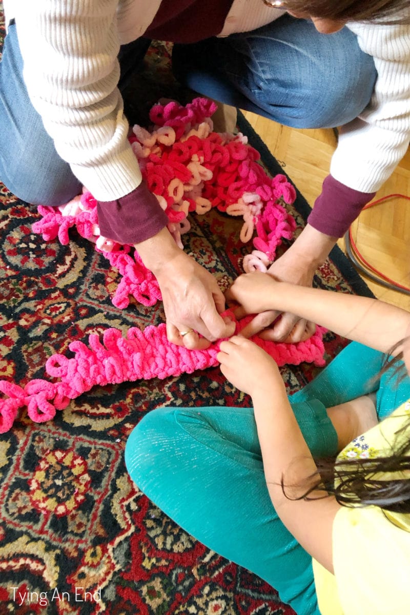 yarn craft with kids finger knitting working together